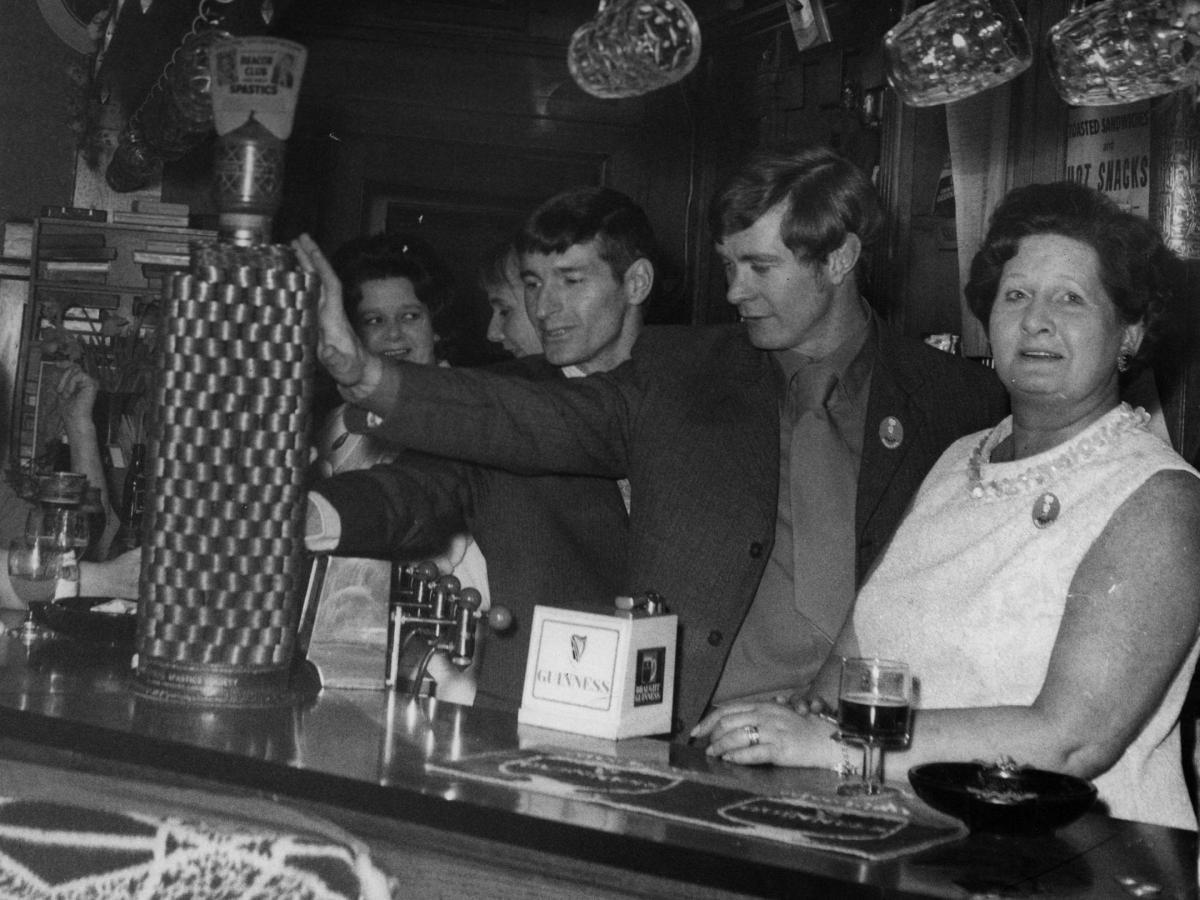 A British pub scene from the 1950s with family members being the bar