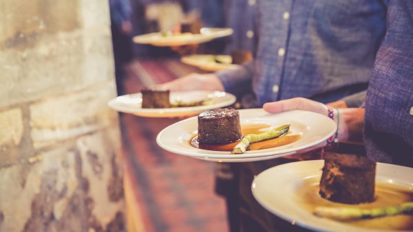 Serving plated mains with sharing sides at The Mount Without wedding venue Bristol